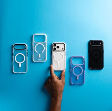 Five Phantom 3 cases laid out on bright blue paper — Clear, Confetti, Lilac and Smoke — with a hand holding the Clear one fitted to a silver iPhone